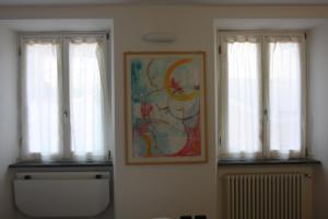 a room with two windows and a painting on the wall at Hotel Gianni Franzi in Vernazza