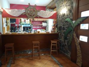 a bar in a restaurant with stools in front of it at Ubilla Aterpetxea in Aulestia