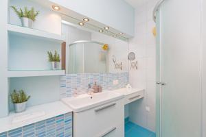 a bathroom with a sink and a mirror at Villa Casia in Mokošica