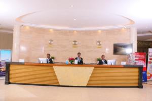 three men sitting at a counter in a mall at Swiss Lenana Mount Hotel in Nairobi