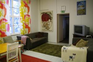 - un salon avec un canapé et une télévision dans l'établissement Aneen Loma Vacation and Cottages, à Posio