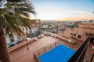 a view from the roof of a building with a swimming pool at Casa de Alhacaba in Granada