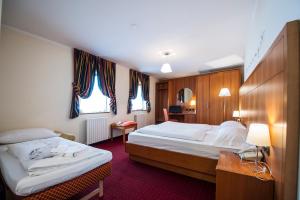 Postel nebo postele na pokoji v ubytování Hotel Touring