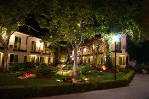 a building with trees and flowers in a yard at night at Laguna Hills Lodge-Irvine Spectrum in Laguna Hills