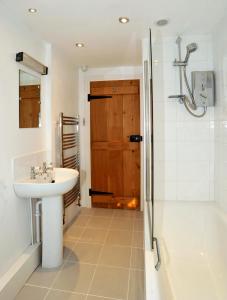 a bathroom with a sink and a shower and a toilet at Bryn Tirion in Morfa Nefyn