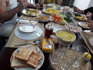 a group of people sitting at a table with food at Ibis in Udawalawe