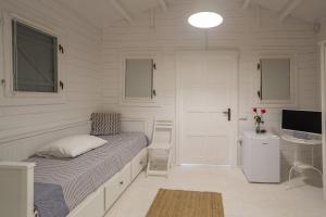 a bedroom with a bed and a desk and a television at Casa De Mare in Olimp