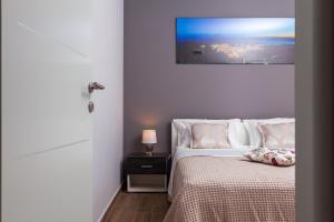 Postel nebo postele na pokoji v ubytování Gold & Silver Apartments