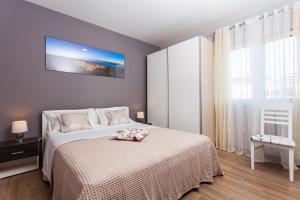Postel nebo postele na pokoji v ubytování Gold & Silver Apartments