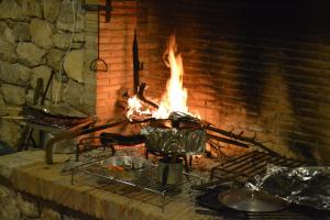 a brick oven with a pot and fire in it at Agriturismo La Torre Rossa in Itri