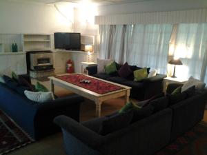 a living room with two couches and a coffee table at Bethel Lodge in Clarens +5 photos