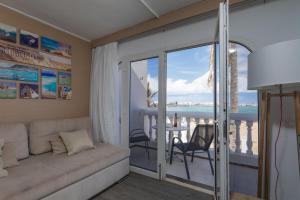 a living room with a couch and a view of the ocean at Galera Beach Apartamentos in Corralejo