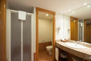 a bathroom with a toilet, sink, and shower at SOMMOS Hotel Benasque Spa in Benasque