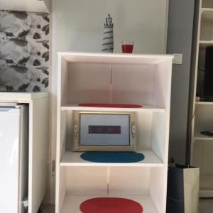 a white book shelf with a microwave in it at Apartment Nikka in Dubrovnik