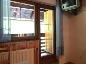 a window in a room with a tv and a window at Apartment Tisa in Solčava