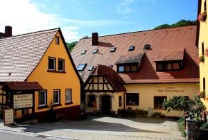 a group of buildings on a street in a town at Gasthof Alte Schreinerei in Rothenburg ob der Tauber