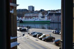 a cruise ship is docked in a harbor with cars at Skansen Hostel in Stavanger