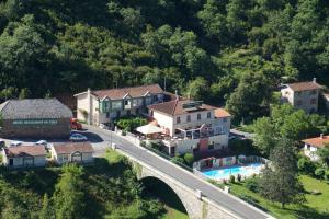 - une vue aérienne sur un village avec un pont dans l'établissement Logis Hotel Restaurant du Pont, à Ambialet