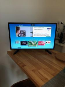 a flat screen tv sitting on top of a wooden table at Studio Saint Anne in Montpellier