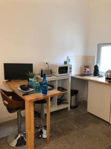 a small kitchen with a table and a microwave at Studio Saint Anne in Montpellier