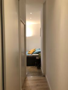 a hallway leading to a bedroom with a bed at Studio Saint Anne in Montpellier