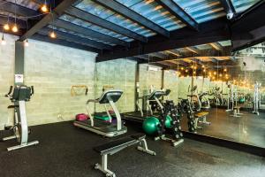 a gym with a bunch of treadms and cardio machines at Riande Urban Hotel in Panama City