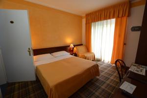 Postel nebo postele na pokoji v ubytování Hotel Astro