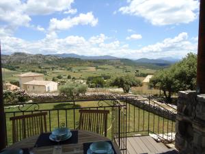 a view from the balcony of a house with a table at le petit coin de Noah in Châteauneuf-Val-Saint-Donat