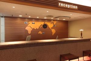 a lobby with a world map on the wall at Daiichi Inn Ikebukuro in Tokyo