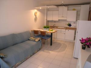 a living room with a couch and a table in a kitchen at Villa Gradenigo in Grado