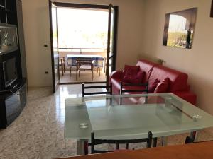 a living room with a red couch and a table at Villa Dora in Grado