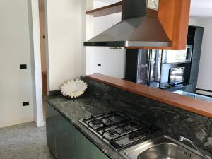 a kitchen with a sink and a stove top oven at Villa Dora in Grado