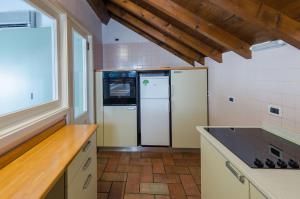a kitchen with a refrigerator and a counter top at Casa del Sole in Finale Ligure
