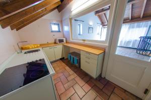 a small kitchen with a counter and a window at Casa del Sole in Finale Ligure +9 photos