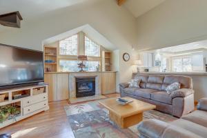 a living room with a couch and a fireplace at 13 Ollalie in Sunriver