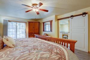 a bedroom with a bed with a ceiling fan at 13 Ollalie in Sunriver