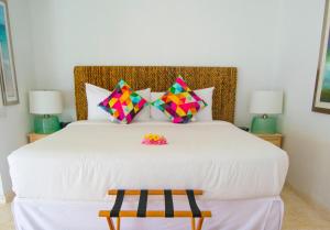 A bed or beds in a room at Bequia Plantation Hotel