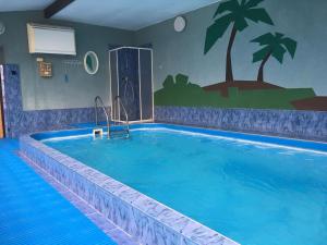 a large swimming pool in a hotel room at Penzion Kycera in Oščadnica