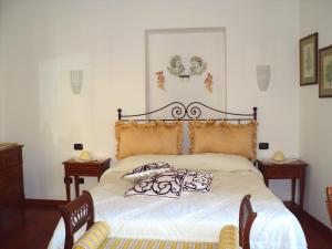 a bedroom with a bed with pillows on it at Casa Mariannina in Maiori