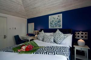 A bed or beds in a room at Bequia Plantation Hotel