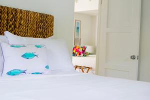 A bed or beds in a room at Bequia Plantation Hotel