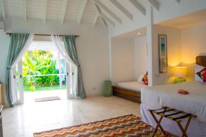 A bed or beds in a room at Bequia Plantation Hotel