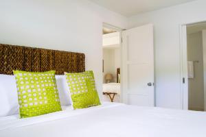 A bed or beds in a room at Bequia Plantation Hotel
