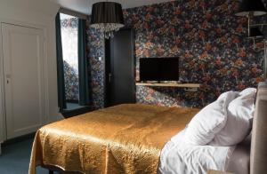 Postel nebo postele na pokoji v ubytování Hotel Duc De Bourgogne