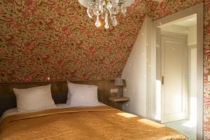 Postel nebo postele na pokoji v ubytování Hotel Duc De Bourgogne