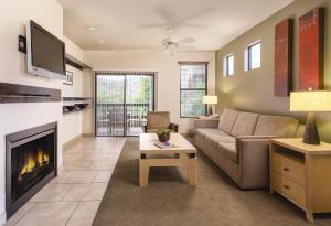 a living room with a couch and a fireplace at WorldMark Phoenix - South Mountain Preserve in Phoenix
