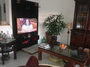 a living room with a tv and a table at BARAKA - Posada in Piriápolis