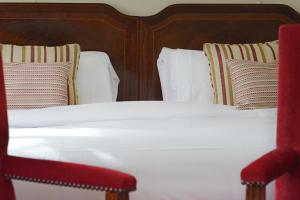 A bed or beds in a room at The Brickwall Hotel 