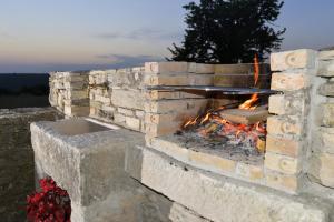 a brick oven with a fire in it at Villa Grguci in Kanfanar