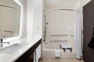 a white bathroom with a sink and a shower at Holiday Inn Express & Suites Lakeland South, an IHG Hotel in Lakeland